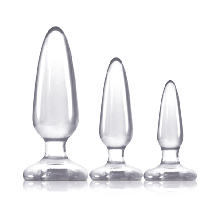 Three clear graduated silicone anal plugs in small, medium, and large sizes with smooth finish and flared bases.