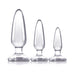 Three clear graduated silicone anal plugs in small, medium, and large sizes with smooth finish and flared bases.