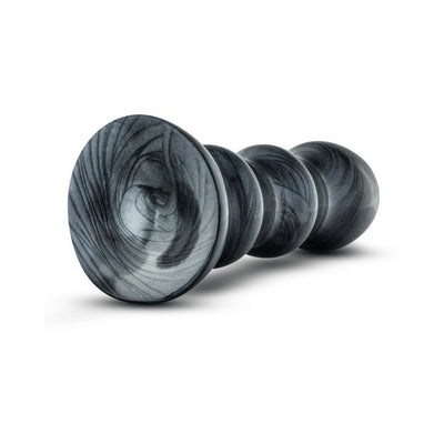 Black and gray marbled flexible PVC bulb toy with flared suction cup base for secure placement.