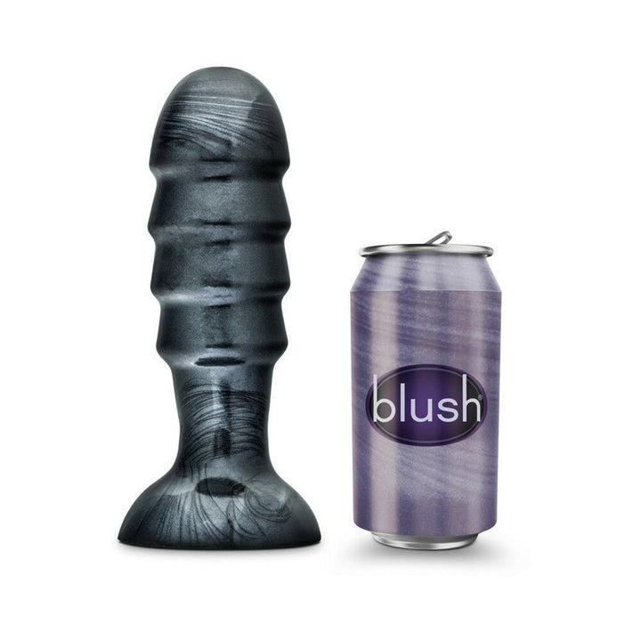 Jet Bruiser Carbon Metallic Black tapered butt plug with suction base next to a purple Blush-branded can for size comparison.