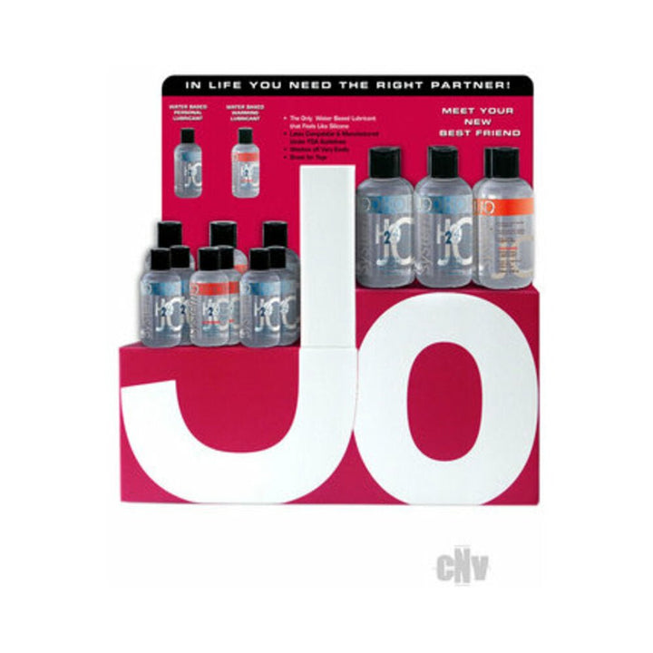 Display of JO brand water-based personal lubricants in small clear bottles with black caps on a red and white branded stand.