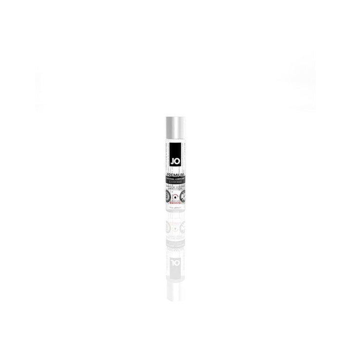 Jo Premium Warming Silicone Lubricant in a sleek 1 oz clear bottle with black and white label on reflective white surface