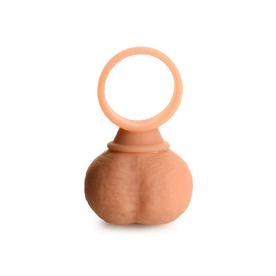 Large vibrating silicone balls with a ring handle, designed for versatile intimate use, in a skin-tone color.