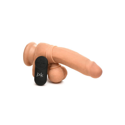 Large flesh-toned vibrating silicone balls with remote control displayed on a realistic silicone model.