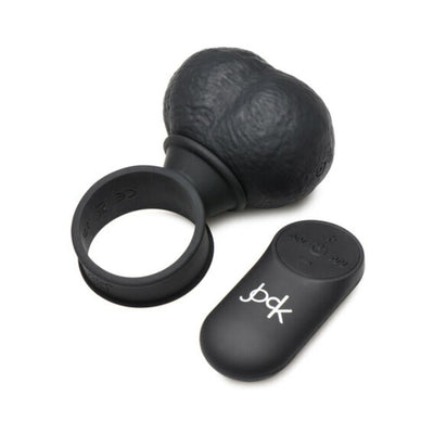 Black silicone vibrating balls with attached ring and matching remote control on white background.