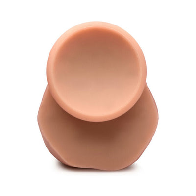Top view of a light skin tone silicone dildo with a wide suction cup base for secure placement.