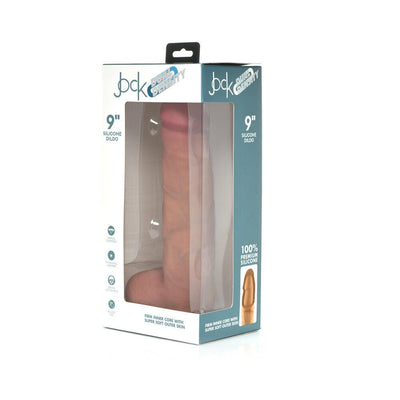 Jock Dual Density 9-inch realistic silicone dildo with suction base in light skin tone, packaged in a clear display box.