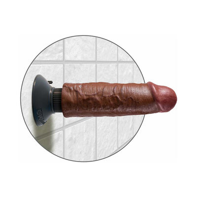 Realistic 6-inch vibrating dildo with suction cup base mounted on tiled wall, dark brown color.