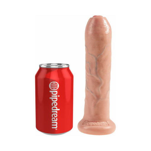 Realistic 7-inch uncut dildo with movable foreskin and suction base next to a red Pipedream soda can for size comparison.