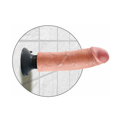 Beige 8-inch realistic vibrating dildo with suction cup base mounted on tiled wall.