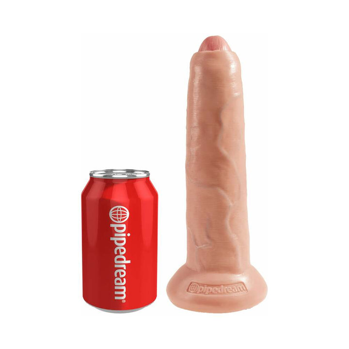 Beige 9-inch uncut dildo with suction base next to a red Pipedream branded can for size comparison.