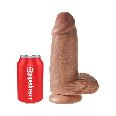 Realistic 9-inch chubby dildo with balls and suction cup base next to a red soda can for size comparison.