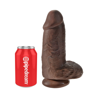 Realistic dark brown 9-inch dildo with suction cup base next to a red Pipedream branded soda can for size comparison.