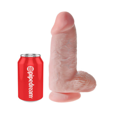 Realistic 9-inch flesh-toned dildo with suction cup base next to a red Pipedream branded can for size comparison.