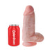 Realistic 9-inch flesh-toned dildo with suction cup base next to a red Pipedream branded can for size comparison.