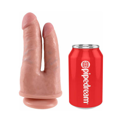 Beige double-ended realistic dildo with suction base next to a red Pipedream soda can for size comparison.