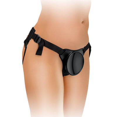 Black adjustable strap-on harness with a circular suction dock worn on a model’s hips.