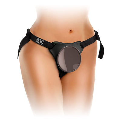 Close-up of a person wearing the adjustable black Body Dock harness with a circular silicone suction dock at the front.