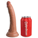 Realistic brown silicone dildo with suction cup base next to a red Pipedream soda can for size comparison.