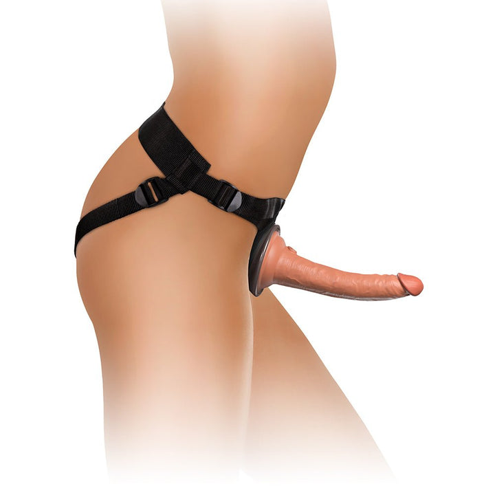 Side view of a strap-on harness with a realistic silicone dildo attached, featuring adjustable black nylon straps.