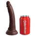 Tan dual-density silicone dildo with suction base next to a red Pipedream soda can for size comparison.