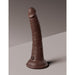 Tan dual-density silicone dildo with suction cup base standing upright on a neutral surface.