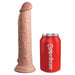 King Cock Elite 9-inch dual-density silicone dildo in light color next to a red Pipedream soda can for size comparison.