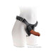 Brown 6-inch realistic dildo attached to black adjustable strap-on harness on white mannequin torso.