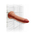 Tan realistic 7-inch triple density dildo with suction base attached to tiled wall.