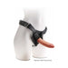 Tan 7-inch realistic triple density dildo attached to a black adjustable strap-on harness on a white mannequin.
