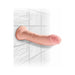 Realistic 8-inch flesh-toned dildo with suction cup base mounted on tiled wall for hands-free use.