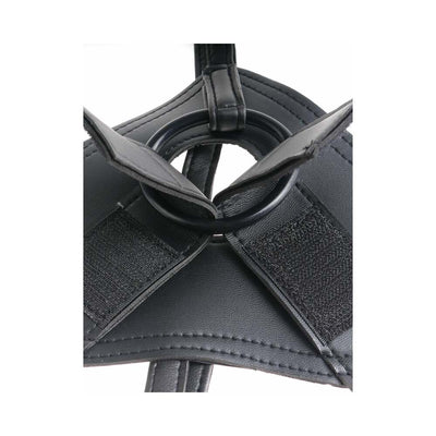 Close-up of black heavy-duty vinyl strap-on harness with adjustable velcro and O-ring detail.