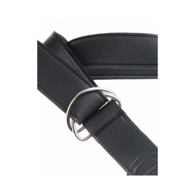 Close-up of black adjustable strap-on harness with metal buckle and stitched detailing