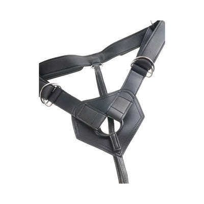 Black adjustable strap-on harness with metal rings and padded center panel for secure fit and comfort.
