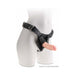 Beige 5-inch realistic dildo attached to a black adjustable strap-on harness on a white mannequin torso.