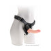 Beige 8-inch realistic dildo attached to a black strap-on harness on a white mannequin torso.