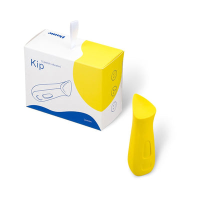 Yellow Dame Kip ergonomic lipstick-shaped vibrator next to its white and yellow packaging box labeled Kip Lemon.