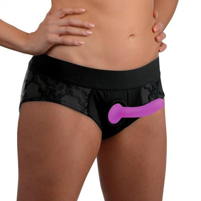 Black lace crotchless panty harness with attached purple silicone dildo worn on model waist