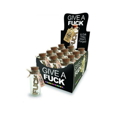 Display box with 12 small glass jars, each containing a wooden word and cork stopper, labeled "Last Fuck I Have To Give" gift jars.