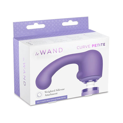 Le Wand Petite Curve Weighted Silicone Attachment in purple displayed on white and lavender packaging box.