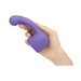 Hand holding a purple silicone Le Wand Petite Curve Attachment designed for targeted stimulation.