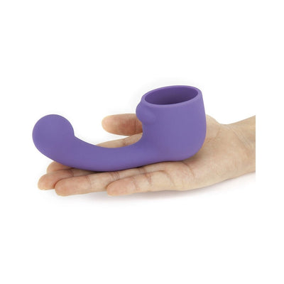 Hand holding a purple silicone curved attachment designed for the Le Wand Petite rechargeable massager.
