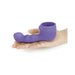Hand holding a purple silicone Le Wand Petite Ripple Attachment designed for targeted stimulation.