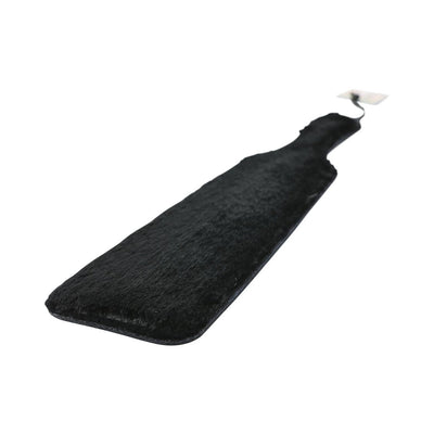 Black leather paddle with soft black faux fur side and wrist strap for secure grip.