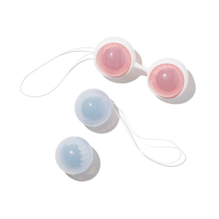LELO Beads in pink and blue with white silicone harness and retrieval loops for discreet pelvic floor training.