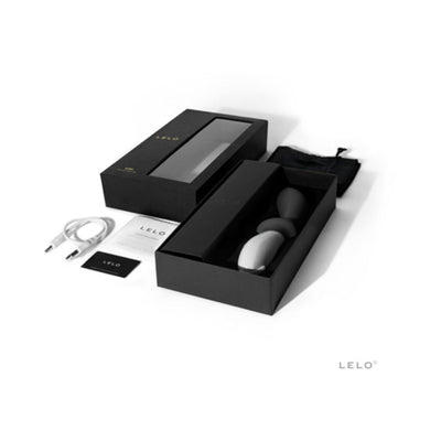 Lelo Loki prostate massager in black box with USB charging cable, satin pouch, and instruction manual on white background.