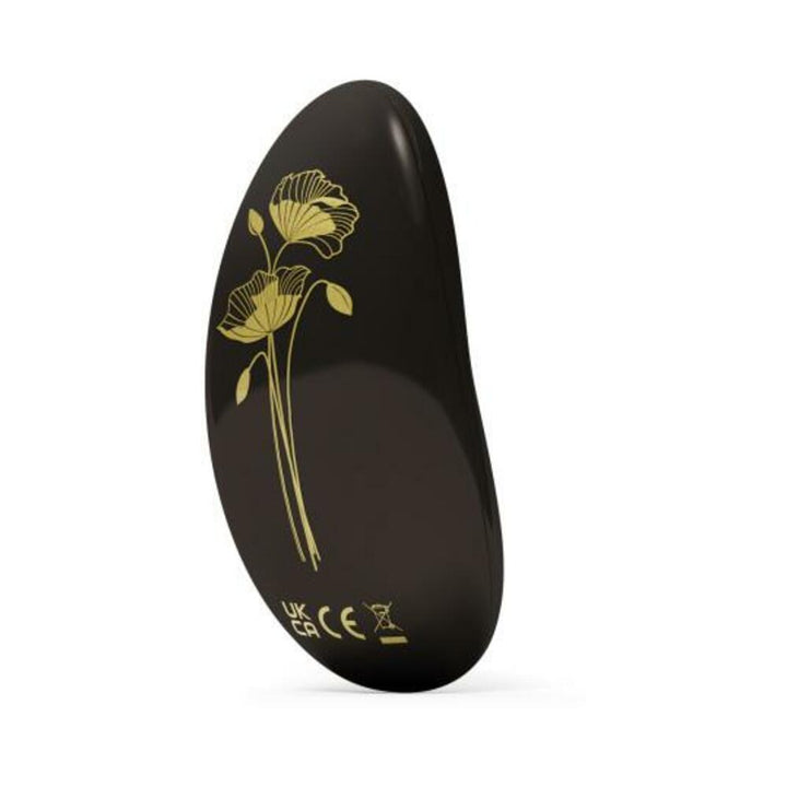 Compact black personal massager with elegant gold floral design, smooth curved shape, and discreet size.