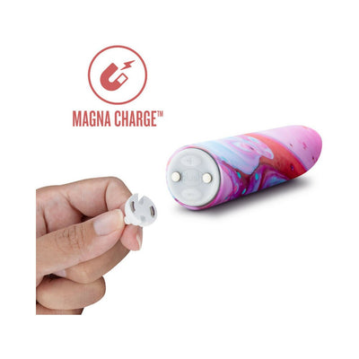 Hand holding magnetic charging connector next to a colorful Limited Addiction Fascinate Power Vibe with Magna Charge feature.