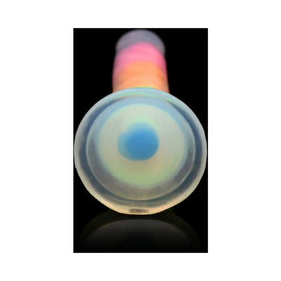 Close-up of the base of a rainbow-colored silicone dildo with a glow-in-the-dark suction cup on a black background.