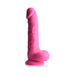 Pink silicone dildo with balls and suction cup base standing upright on white background
